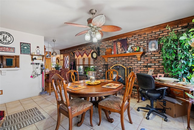 dining space featuring ceiling fan, light tile patterned flooring, and brick wall