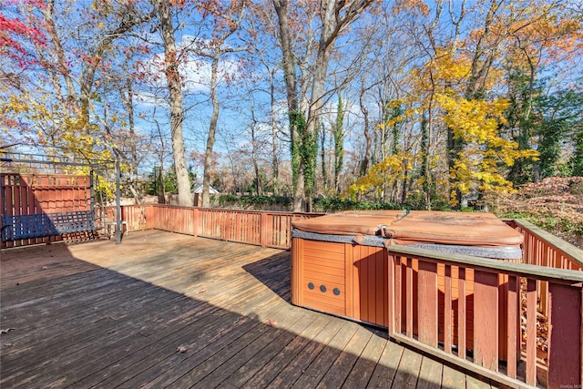 wooden deck with a hot tub