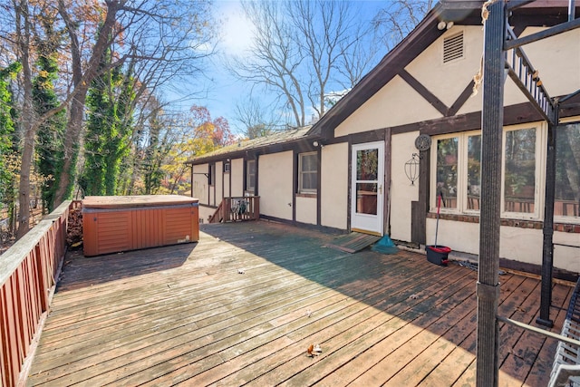 wooden deck with a hot tub