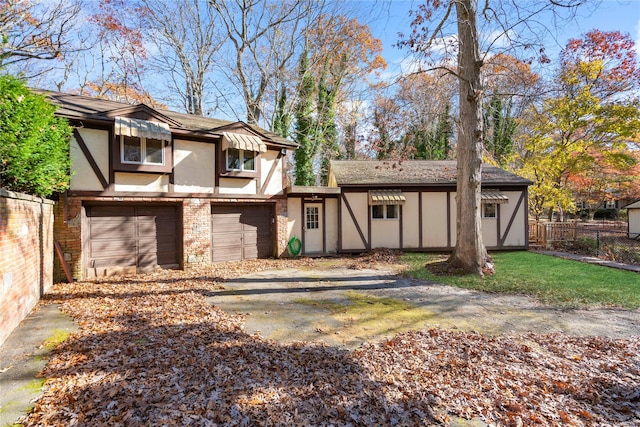 rear view of house featuring a garage