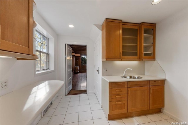 kitchen featuring sink and light tile patterned flooring