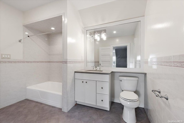 bathroom with tile patterned flooring, vanity, toilet, and tile walls