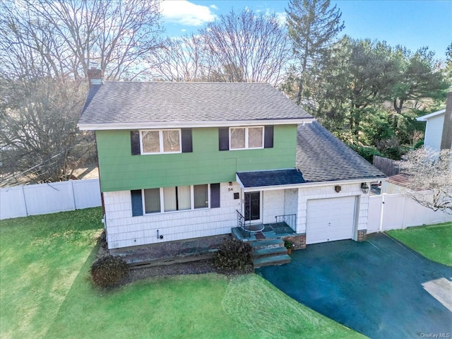 view of front of house with a garage and a front yard