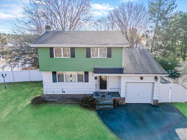 view of front facade featuring a garage and a front lawn