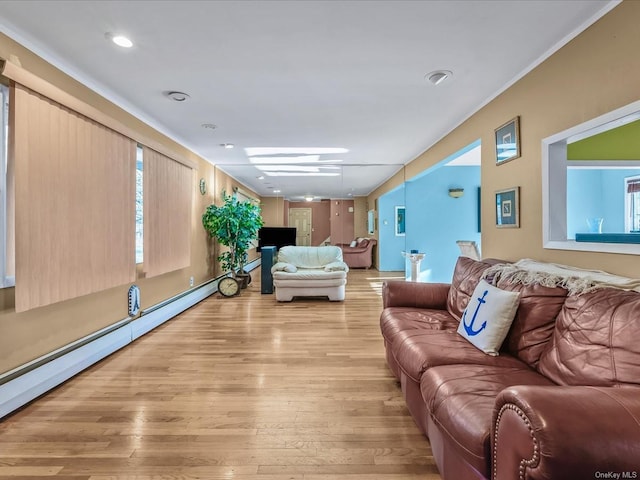 living room featuring light wood-type flooring and a baseboard heating unit