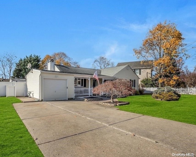 view of front facade featuring covered porch, a garage, and a front lawn