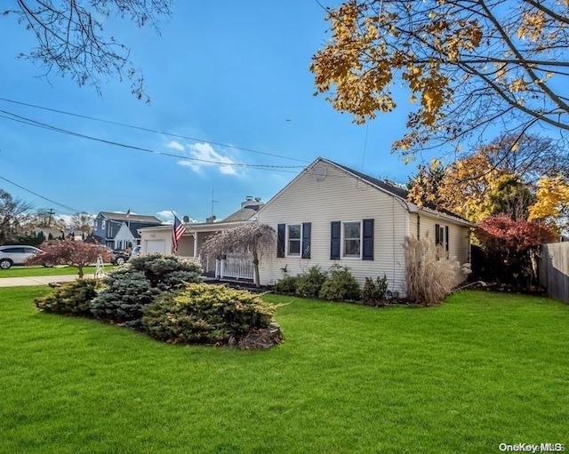 view of side of home with a lawn