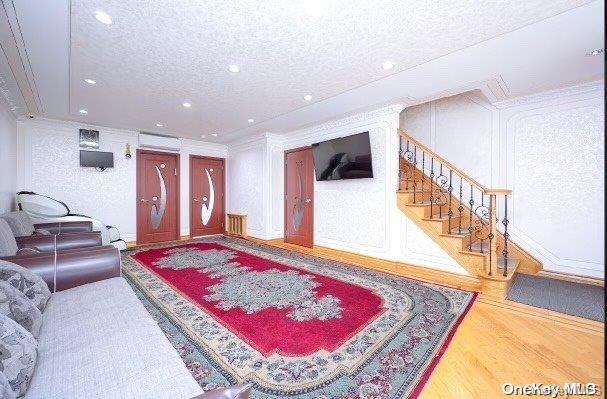 living room with wood-type flooring and a textured ceiling