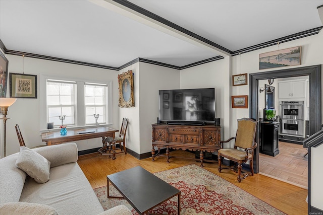 living room with light wood-type flooring and ornamental molding