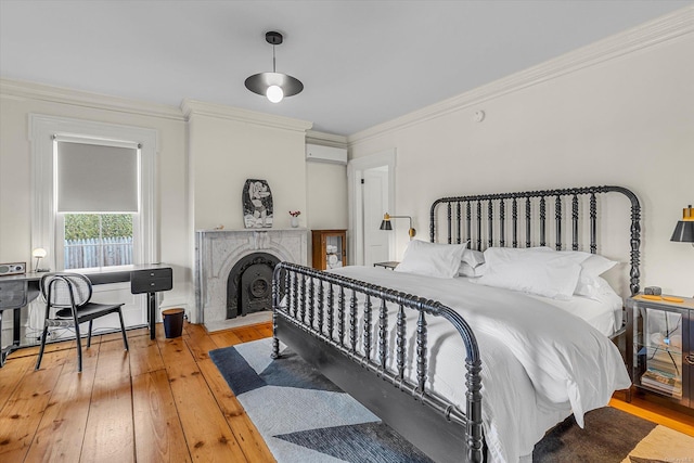 bedroom with crown molding and light hardwood / wood-style floors