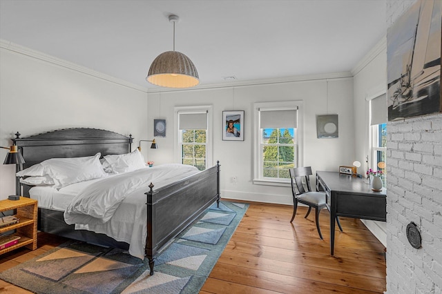 bedroom featuring hardwood / wood-style floors and crown molding