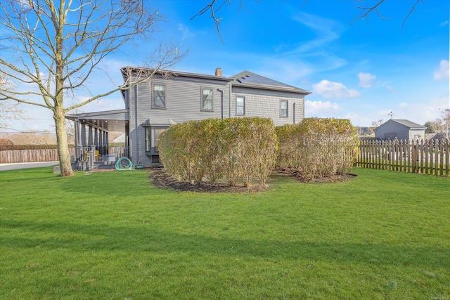 back of property featuring a lawn and a sunroom