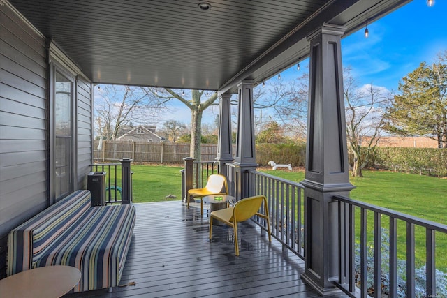 wooden terrace with a porch and a yard