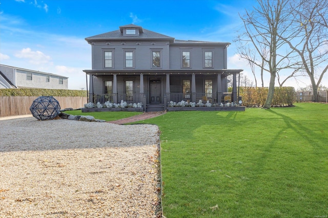 view of front facade with covered porch and a front yard