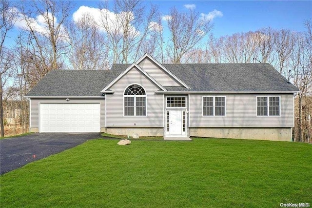 view of front of house with a front yard and a garage