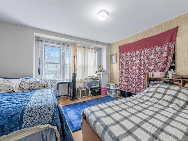 bedroom featuring wood walls