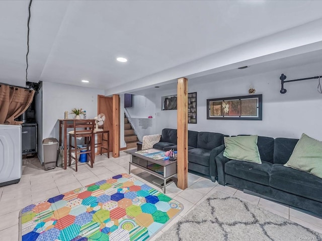 tiled living room featuring washer / clothes dryer