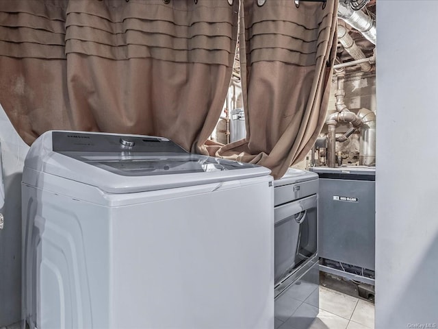 laundry area with light tile patterned floors