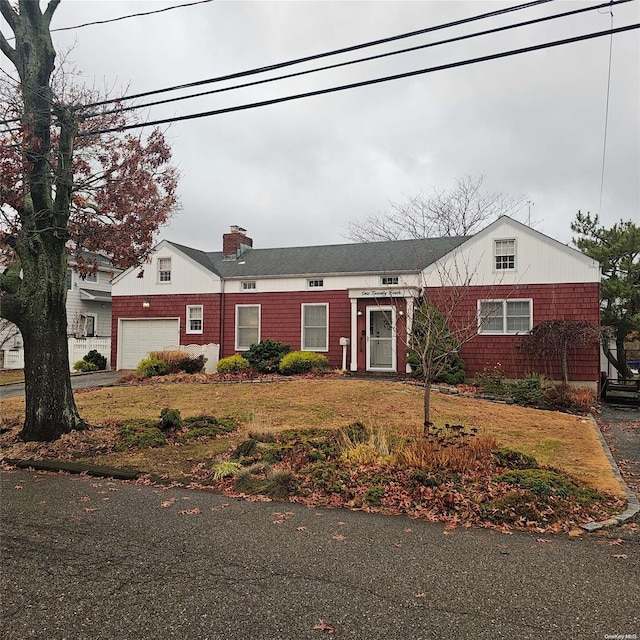 124 Mayhew Ave, Babylon, NY 11702 - view of front of property featuring a chimney, a garage, and a front yard
