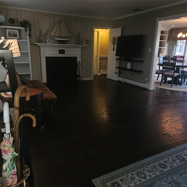 124 Mayhew Ave, Babylon, NY 11702 - living area with ornamental molding, a chandelier, a fireplace, and dark wood finished floors