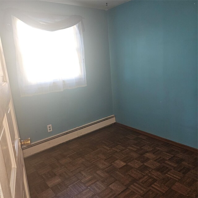 124 Mayhew Ave, Babylon, NY 11702 - spare room featuring a baseboard heating unit and baseboards