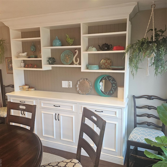 interior space featuring white cabinetry and dark wood-type flooring