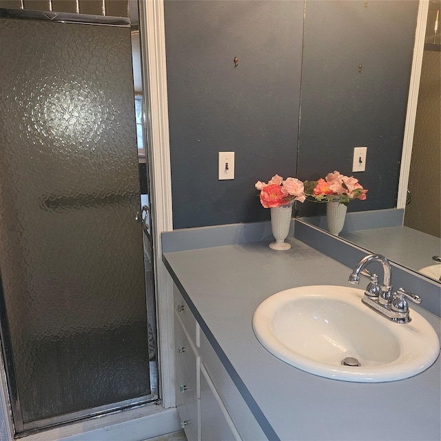 bathroom featuring vanity and an enclosed shower