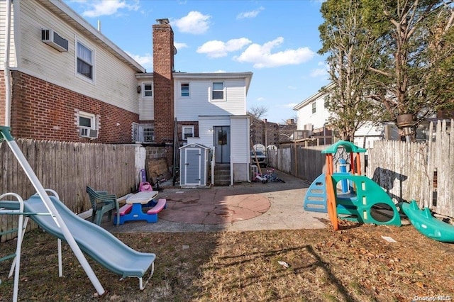 view of jungle gym with a storage shed