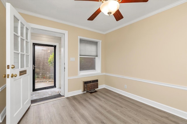 21 S Village Ave Unit 3, Rockville Centre, NY 11570 - foyer entrance with crown molding, light wood-style flooring, a ceiling fan, baseboards, and heating unit