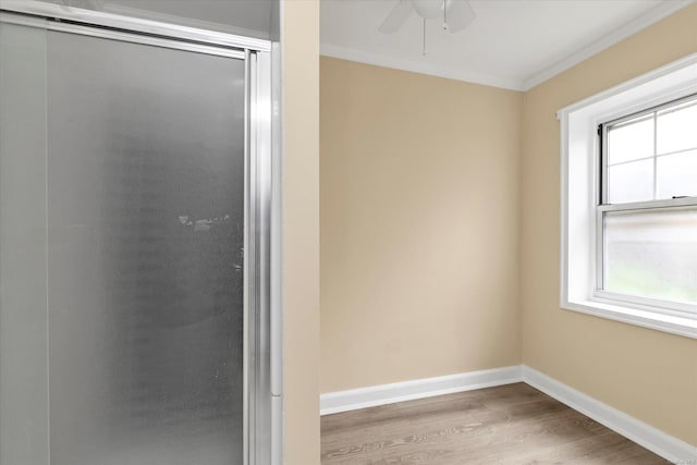 21 S Village Ave Unit 3, Rockville Centre, NY 11570 - bathroom featuring crown molding, a ceiling fan, baseboards, and wood finished floors