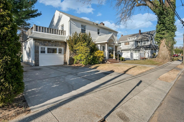 front facade with a balcony and a garage