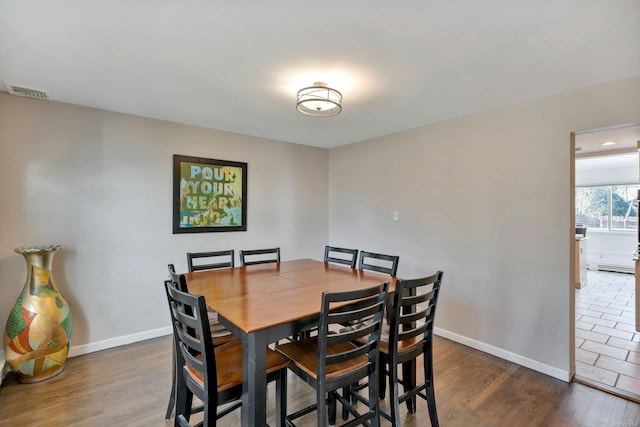 dining space featuring dark hardwood / wood-style flooring