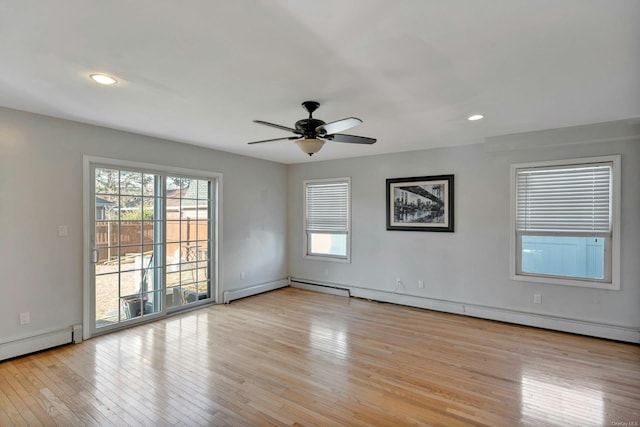 empty room with ceiling fan, light hardwood / wood-style floors, and a baseboard radiator