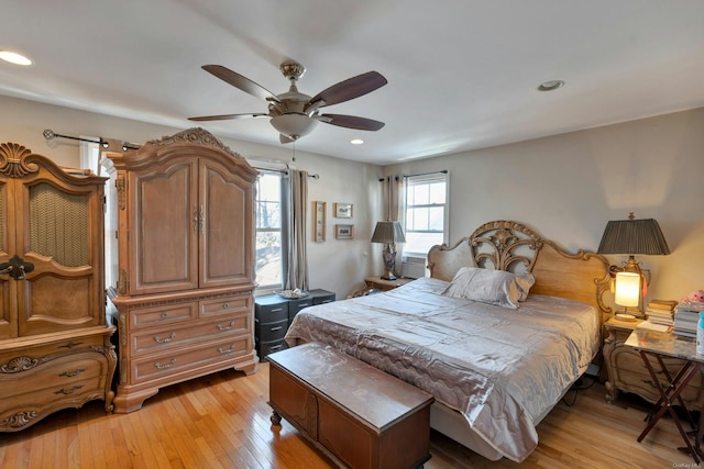 bedroom with ceiling fan and light hardwood / wood-style flooring