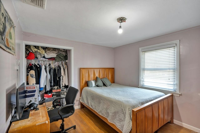 bedroom with light wood-type flooring and a closet