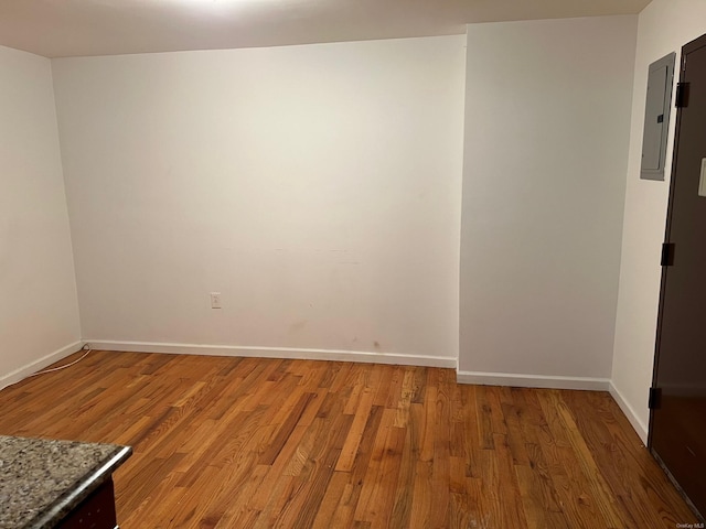 2131 Bruckner Blvd, Bronx, NY 10472 - empty room with electric panel, light wood-style flooring, and baseboards