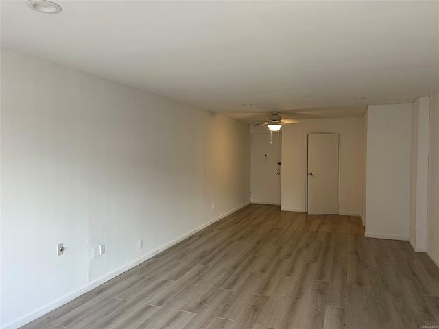 unfurnished room featuring ceiling fan and light hardwood / wood-style floors