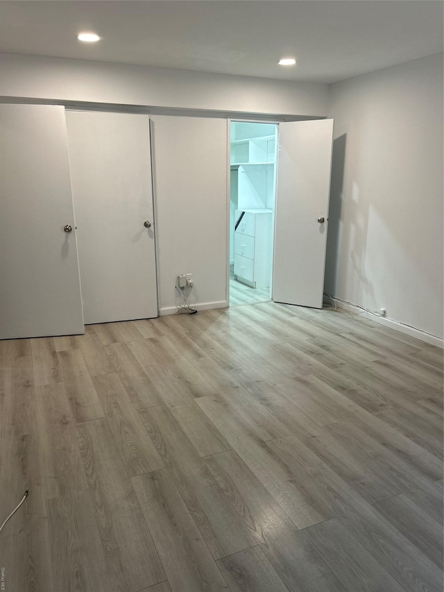 spare room featuring wood-type flooring