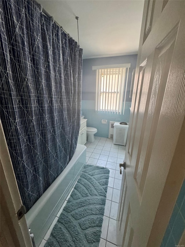 bathroom featuring tile patterned floors, toilet, vanity, and tile walls