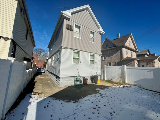 view of snow covered rear of property