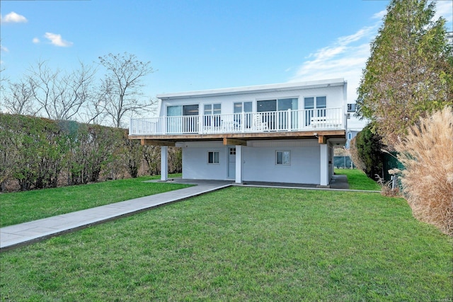 view of front facade with a wooden deck and a front yard