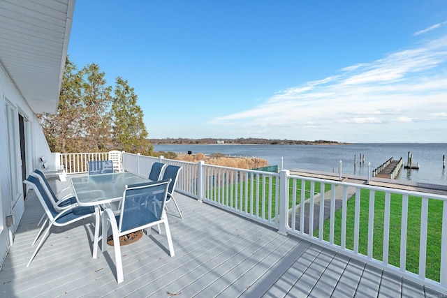 wooden terrace with a boat dock, a water view, and a yard