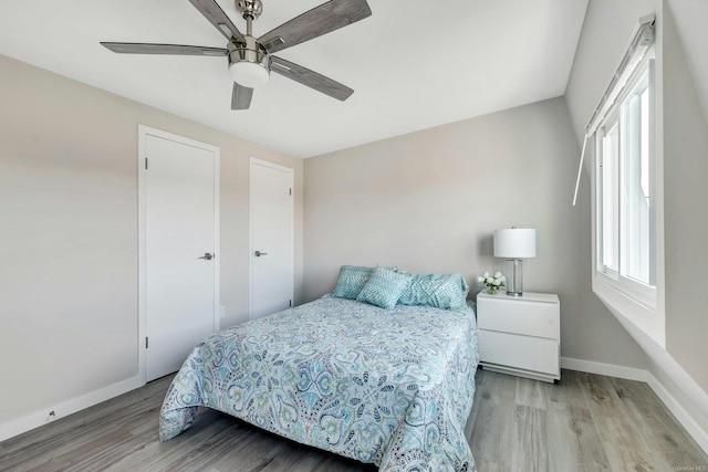 bedroom featuring light hardwood / wood-style floors and ceiling fan