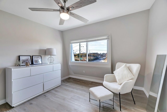 living area with ceiling fan and light wood-type flooring