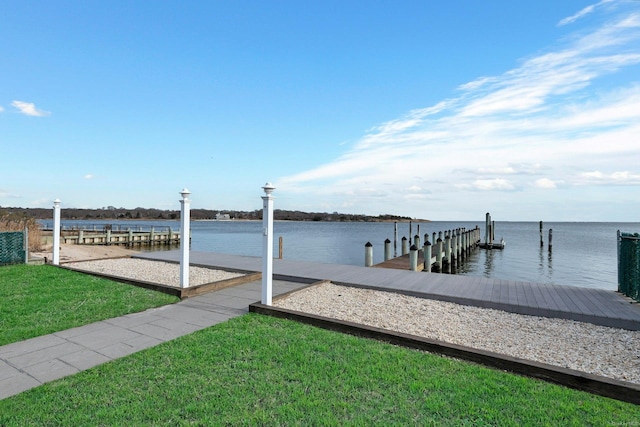 view of dock featuring a yard and a water view