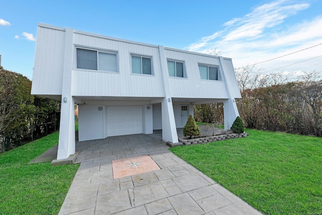 view of front of home with a front yard and a garage