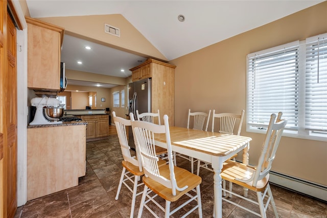 dining room with a baseboard radiator and vaulted ceiling