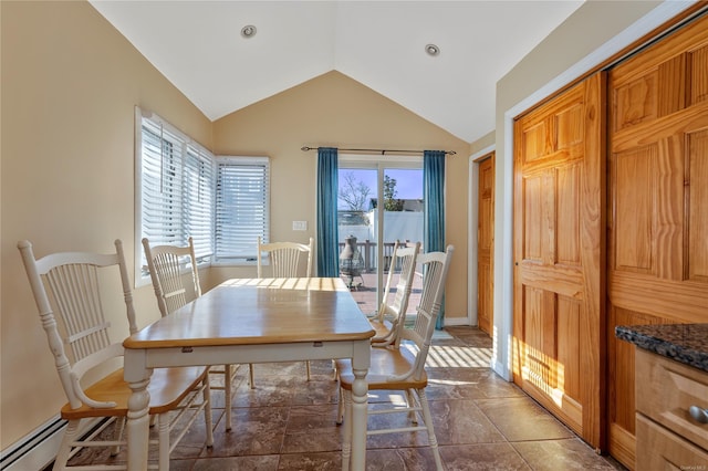 dining space featuring vaulted ceiling and baseboard heating