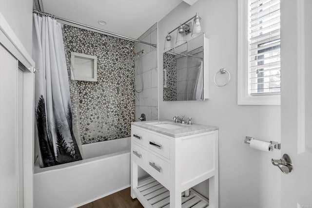 bathroom featuring wood-type flooring, vanity, and shower / tub combo with curtain