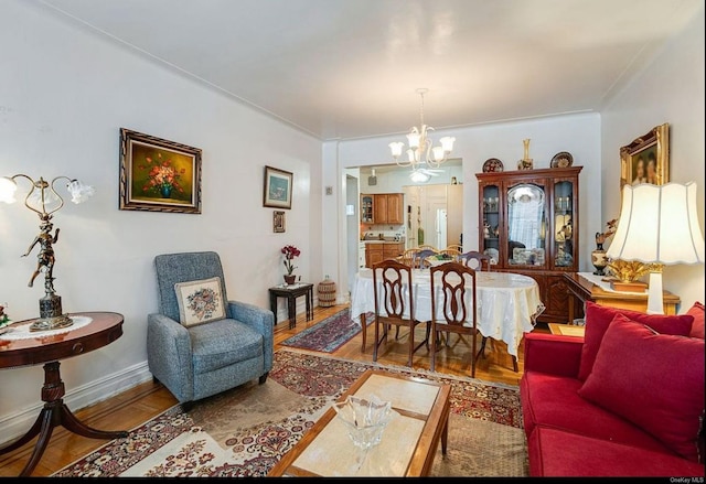 living room featuring hardwood / wood-style floors and an inviting chandelier